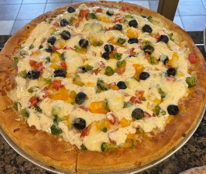 Neapolitan deluxe pizza with toppings at Aldo's Pizza
